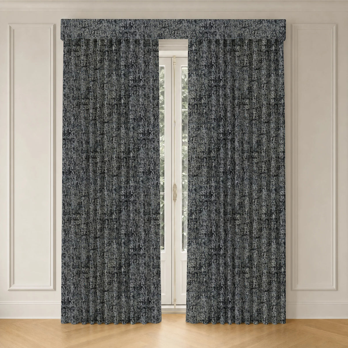 A pair of textured gray and black curtain panels hanging on either side of a tall window in a white paneled room with light wood flooring.