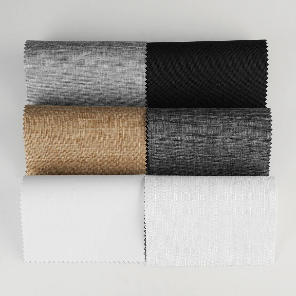 Five fabric swatches with serrated edges arranged in a 2x3 grid on a light gray background. The top row shows gray and black textured fabric, and the bottom row shows tan, dark gray, and white textured fabric.