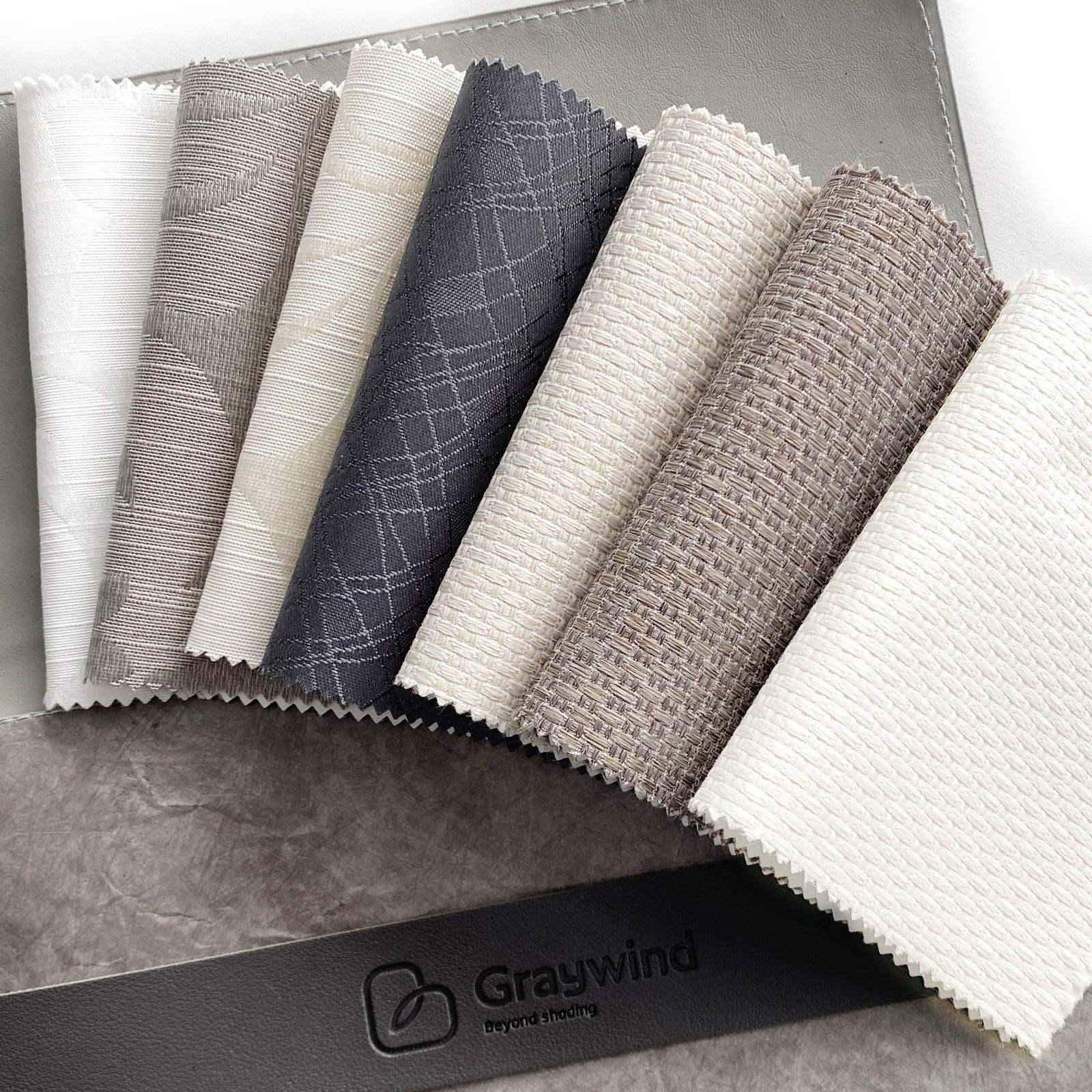 Assorted smart window treatment fabric swatches in neutral tones with textured patterns