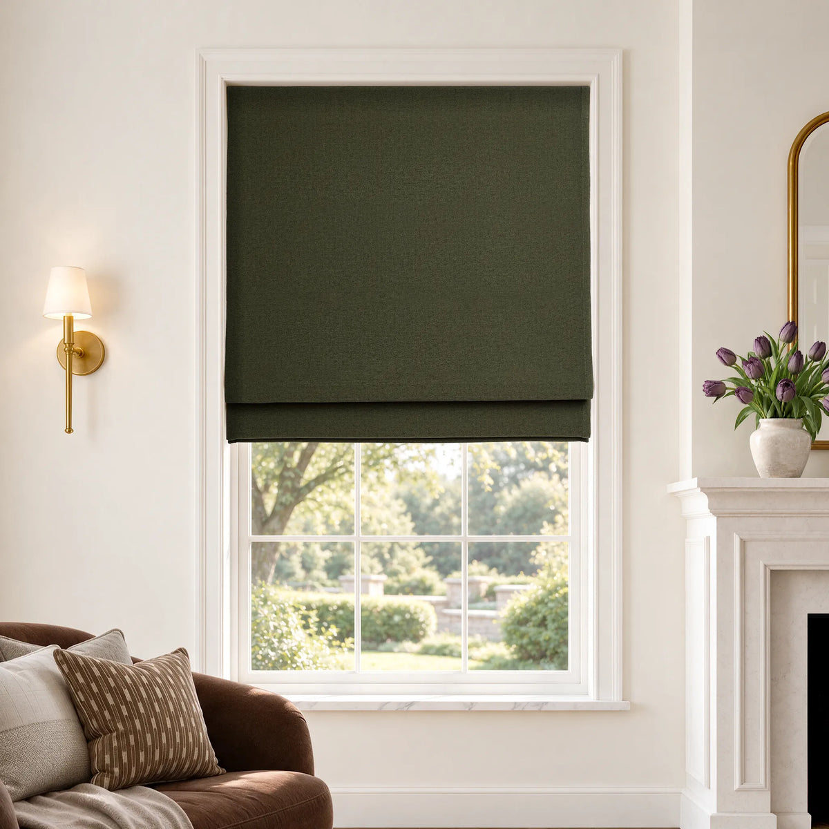 Flat Roman shades in Lush Moss blackout fabric, partially raised on a window.