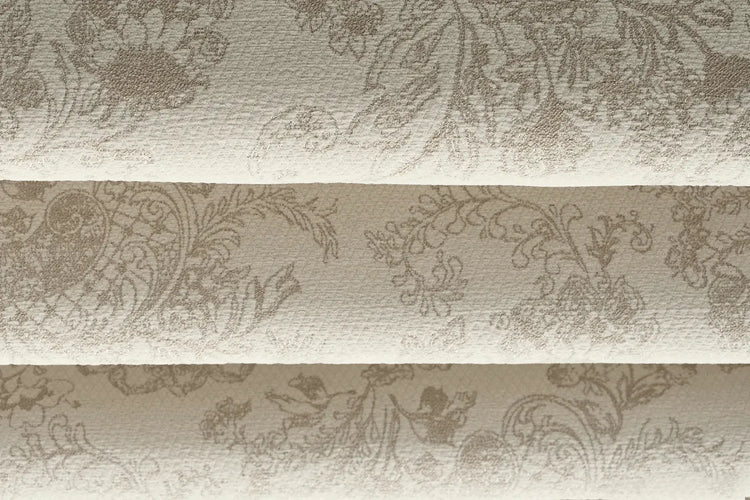 Close-up of Bloom Beige room-darkening fabric for flat roman shades, showing beige fabric with a botanical pattern.