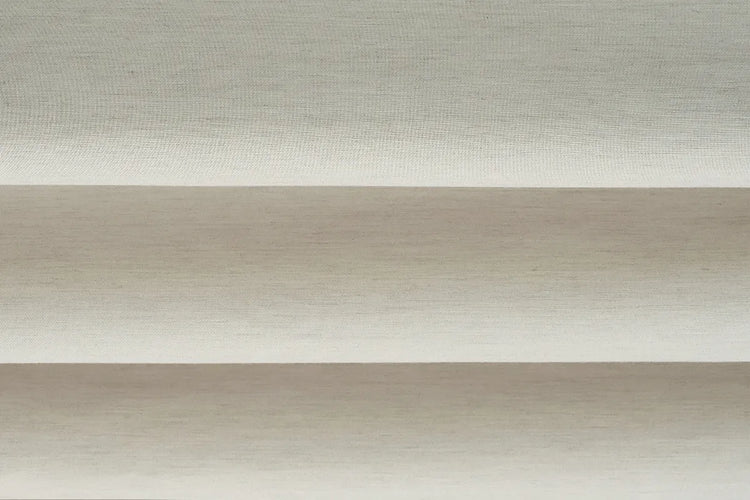Close-up of Linear Wool White light-filtering fabric for flat roman shades, showing white fabric with a fine linear texture.