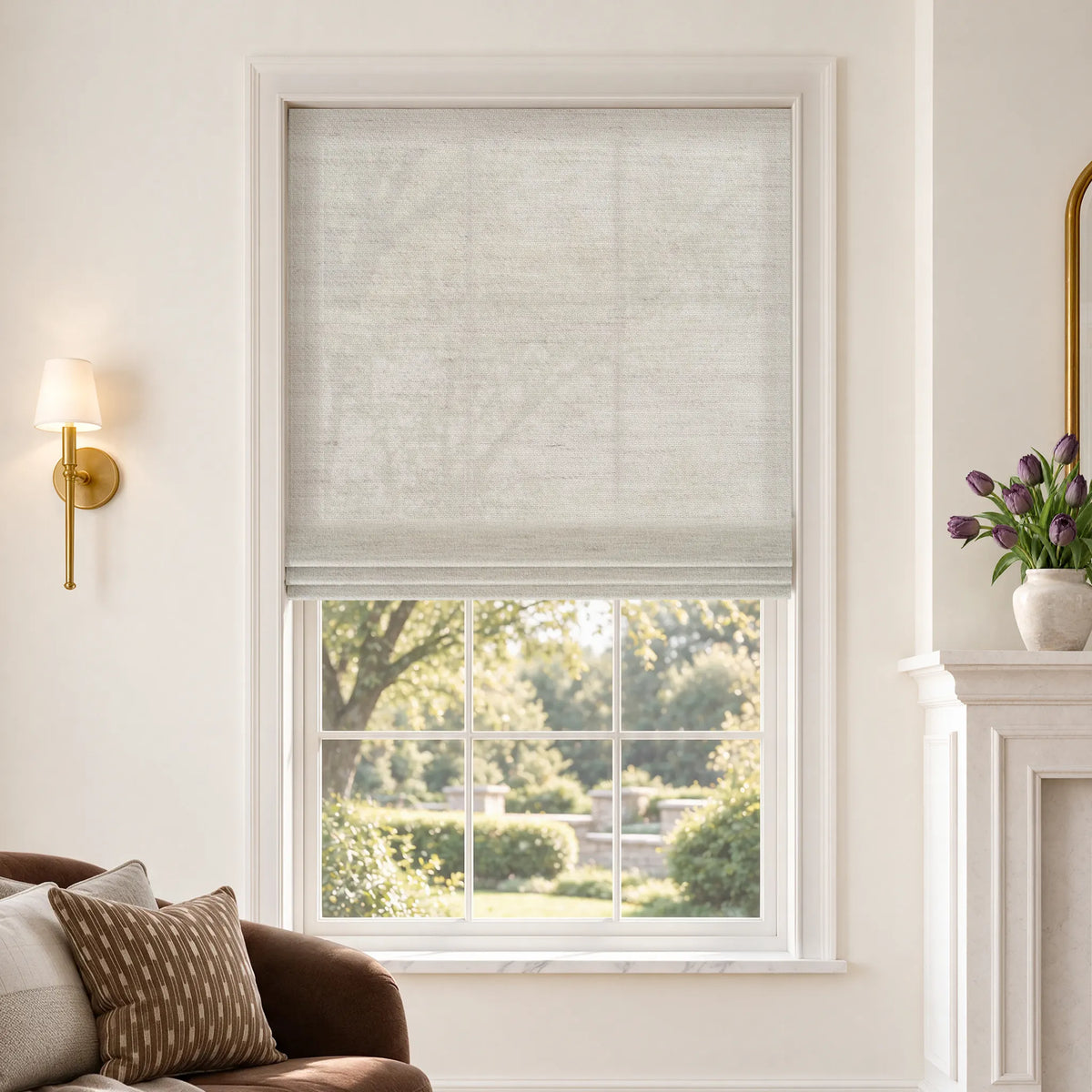 Flat Roman shades in Linear Wool White light-filtering fabric, partially raised on a window.