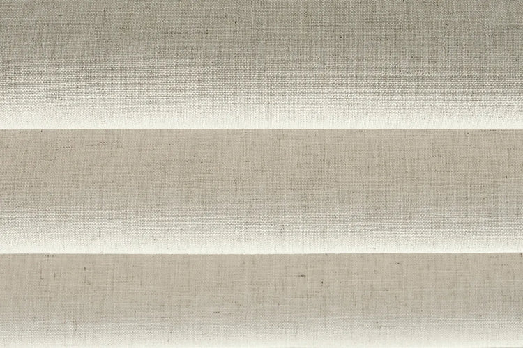 Close-up of Hush Beige light-filtering fabric for flat roman shades, showing beige woven fabric texture.