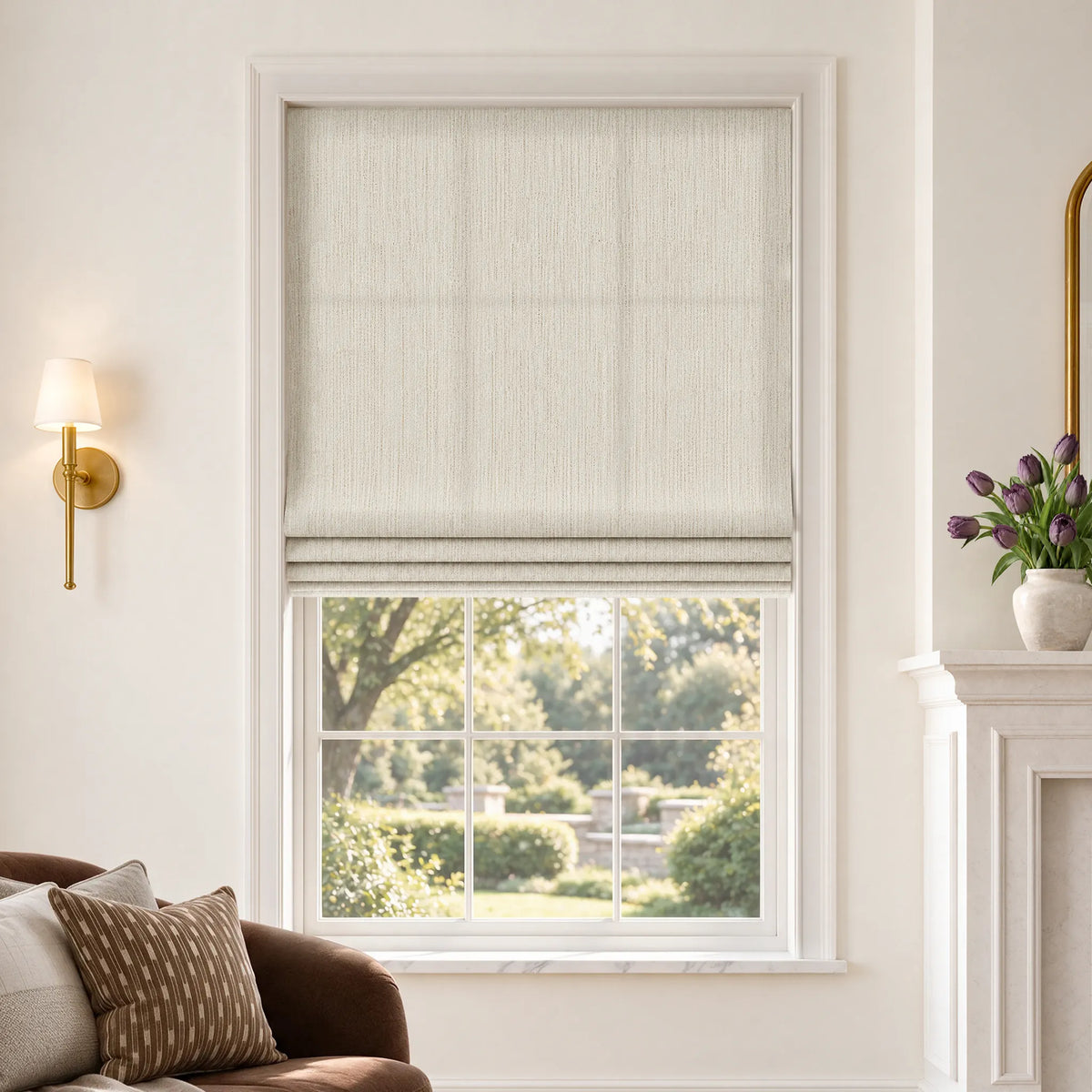 Flat Roman shades in Gilded Cream light-filtering fabric, partially raised on a window.