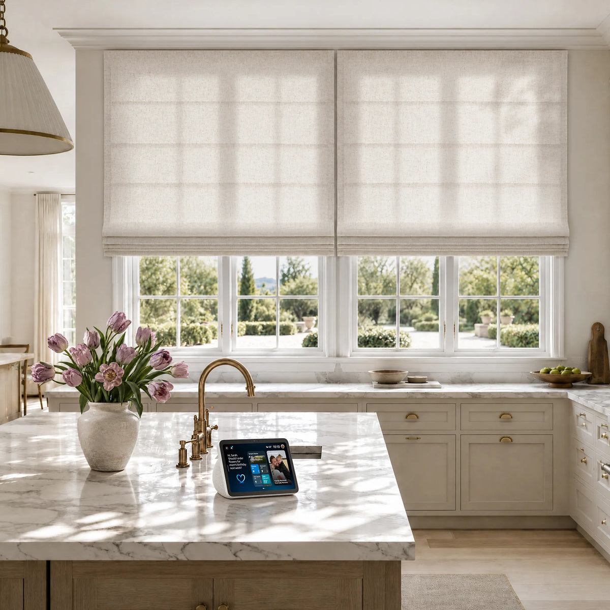 Flat Roman shades above a kitchen sink, with a smart display on the counter.