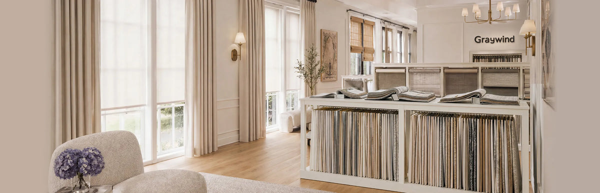 Graywind Dealer Program hero image featuring a premium window treatment showroom with curtains, shades, fabric samples, and dealer partnership solutions
