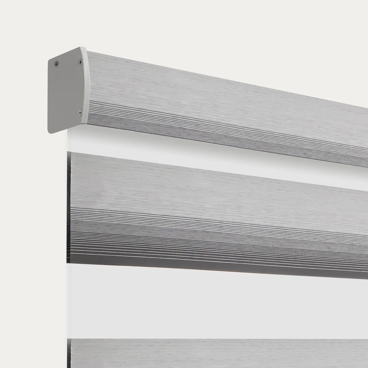 Close-up of a motorized room-darkening zebra blind with a brushed silver headrail and alternating fabric bands.