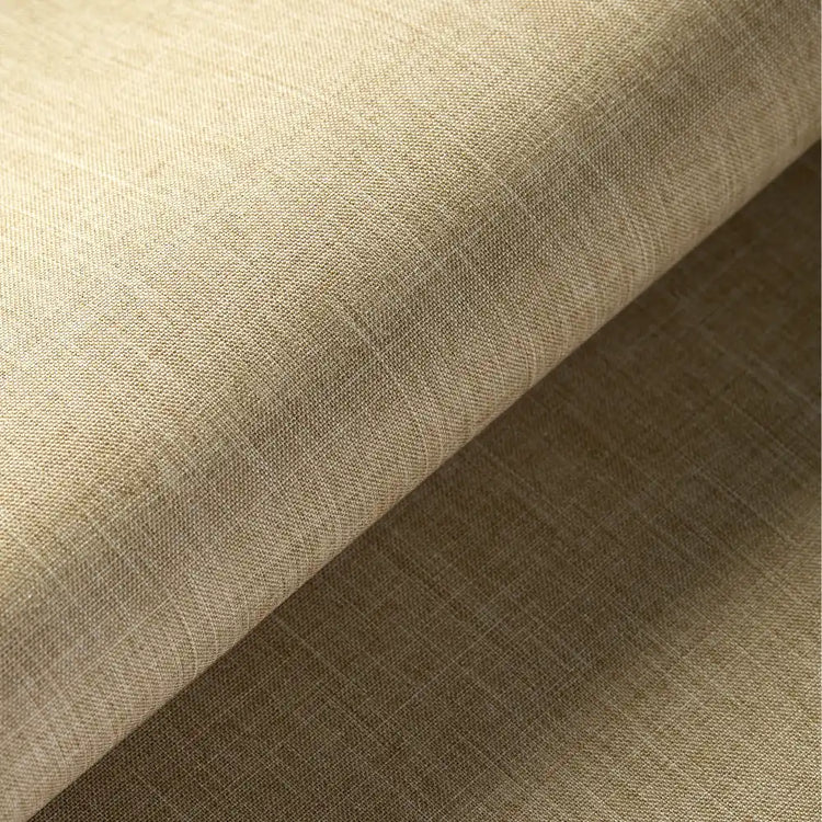 A close-up of a beige woven fabric with a subtle linen-like texture, shown folded diagonally to highlight its texture and color.