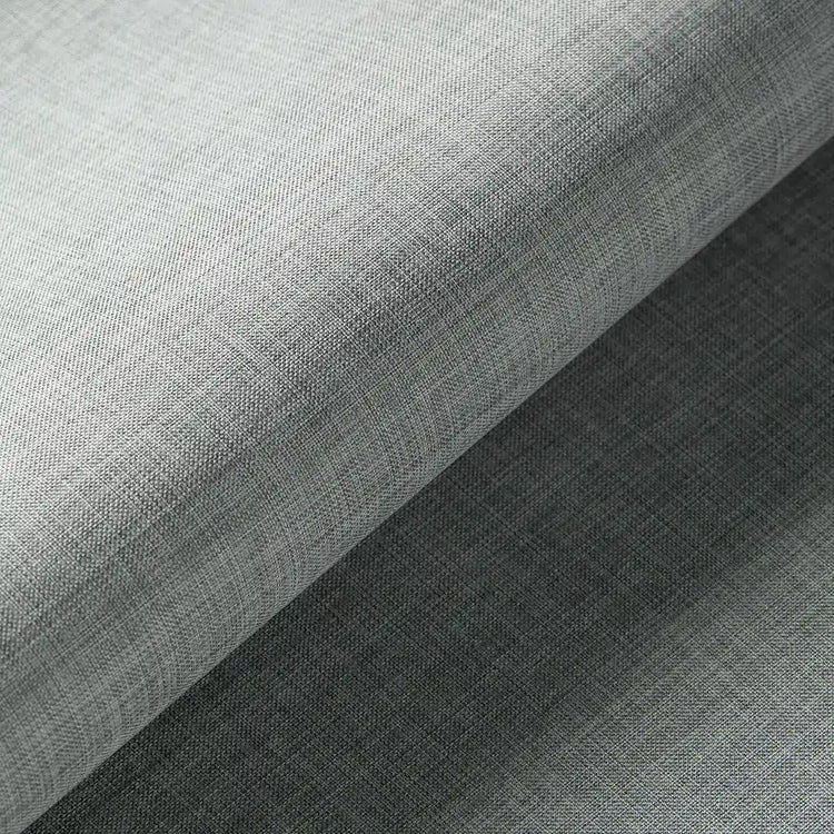 A close-up of a light gray textured fabric with a subtle woven pattern, folded diagonally to show its texture and drape.