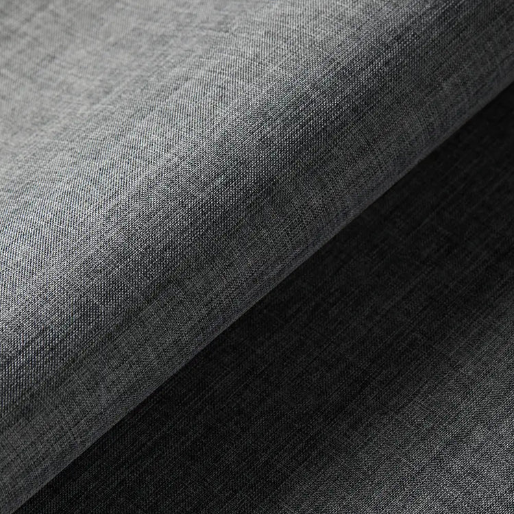 A close-up of dark gray woven fabric with a visible texture, folded diagonally to show the material and color.