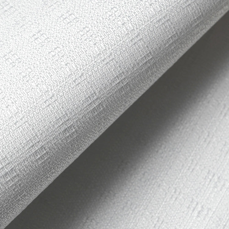 A close-up of a light gray textured wallpaper or fabric roll, showing a fine woven pattern and a diagonal fold that creates a soft shadow.