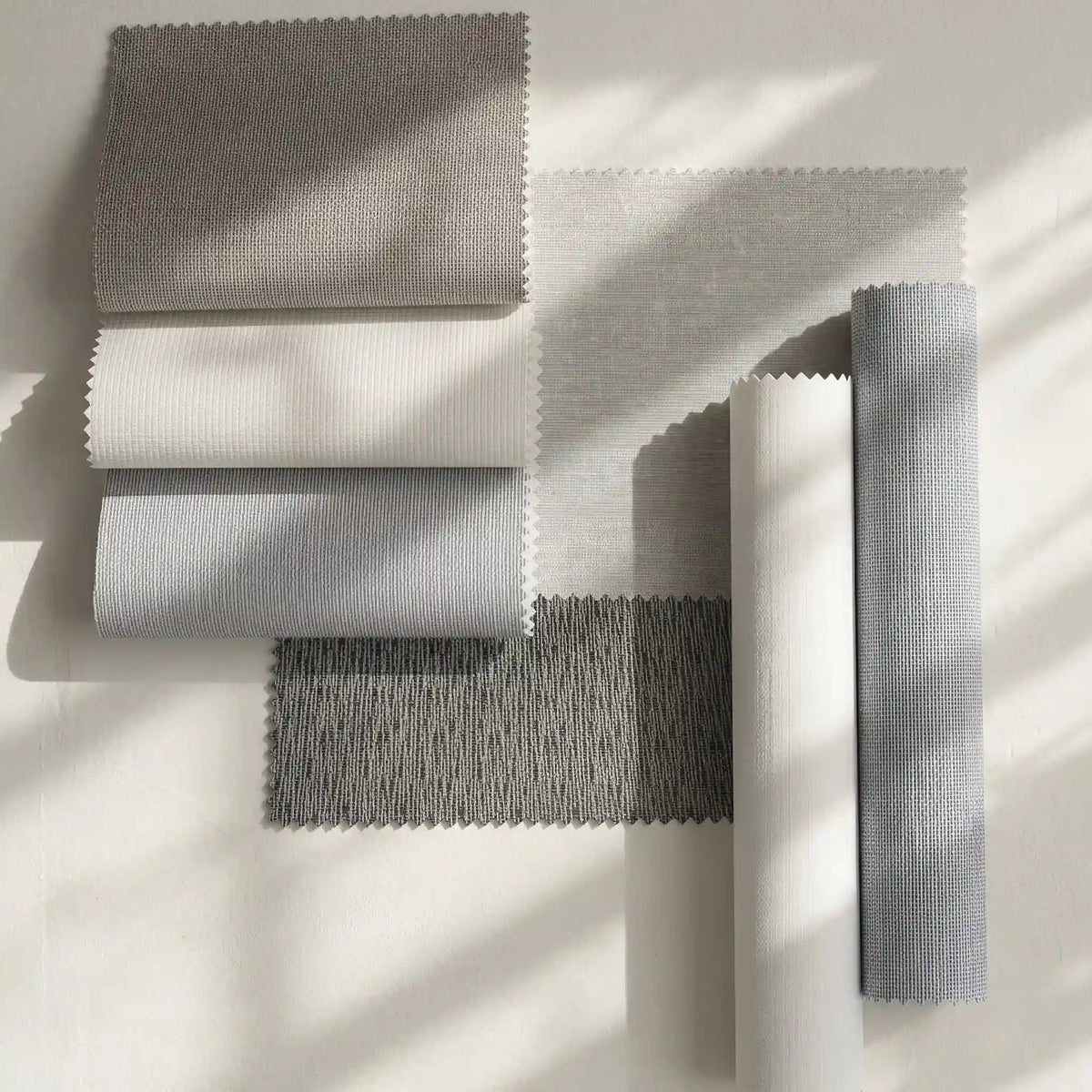 assorted blackout fabric swatches in neutral gray beige and white tones