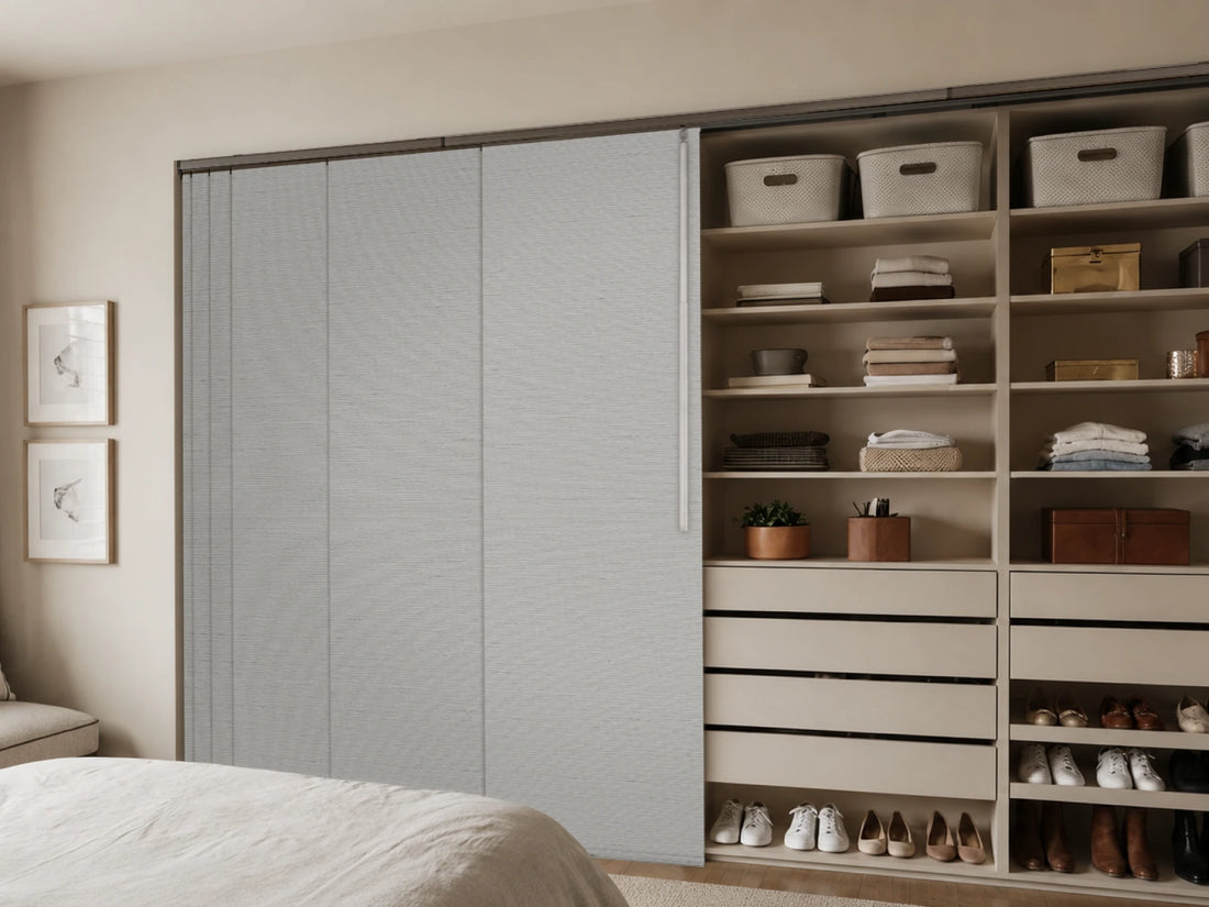 light gray panel track blinds used as closet door coverings in a bedroom