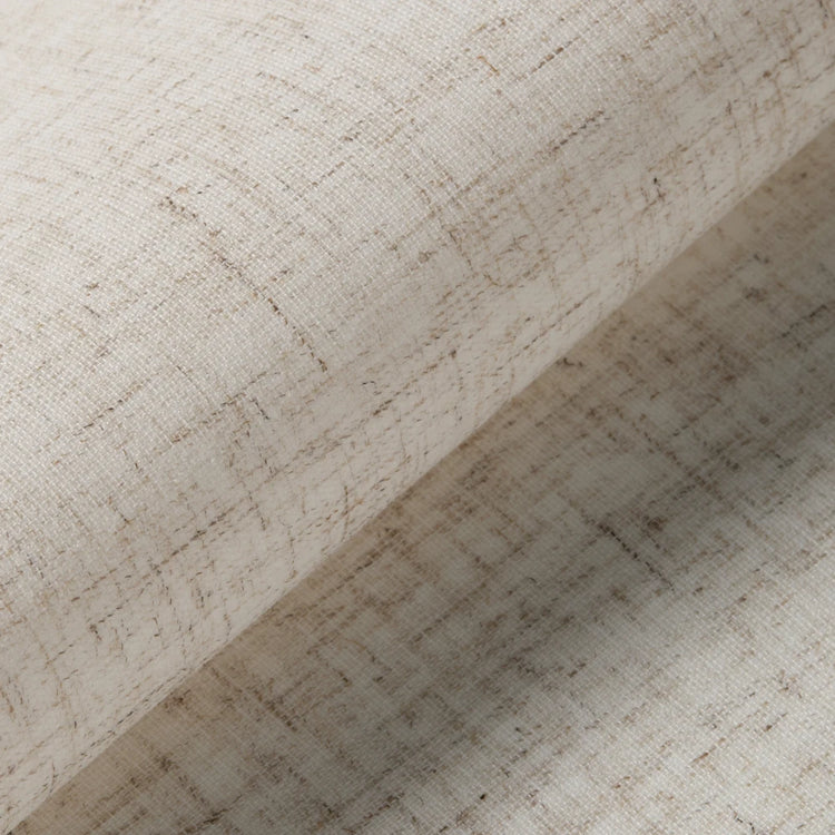 A close-up of a rolled piece of textured fabric in a warm off-white or cream tone with subtle beige and light brown woven fibers visible throughout.