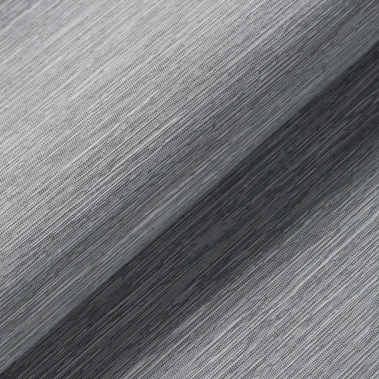 A close-up of a gray ribbed knit fabric texture with a diagonal fold creating a lighter and darker gray striped pattern.