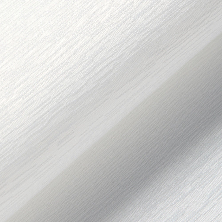 A close-up of a white textured material with a subtle diagonal shadow and fine ribbed surface detail.