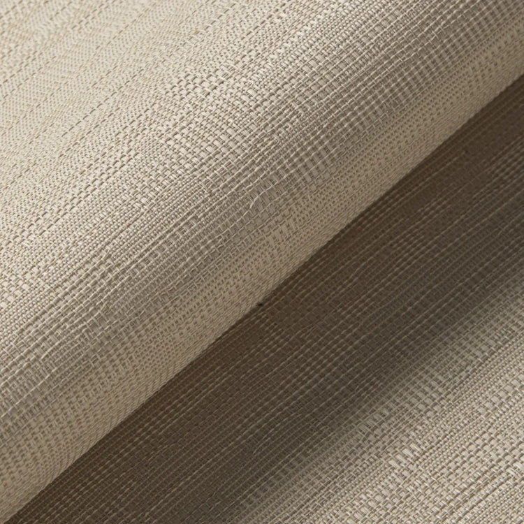 A close-up of a textured woven fabric in a warm taupe-beige color, folded diagonally to show the material's texture and drape.