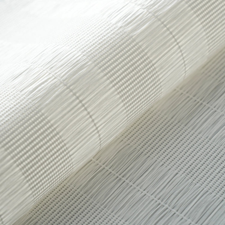 A close-up of a white woven mesh or fabric material with a rolled section showing its texture and grid pattern.