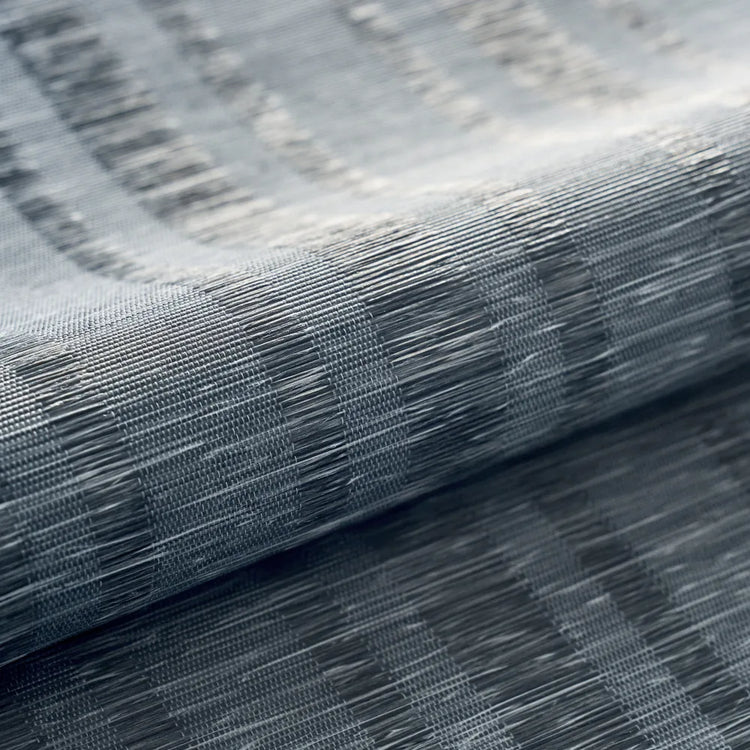 A close-up of a textured gray woven fabric with a subtle striped pattern, shown folded to highlight its weave and drape.