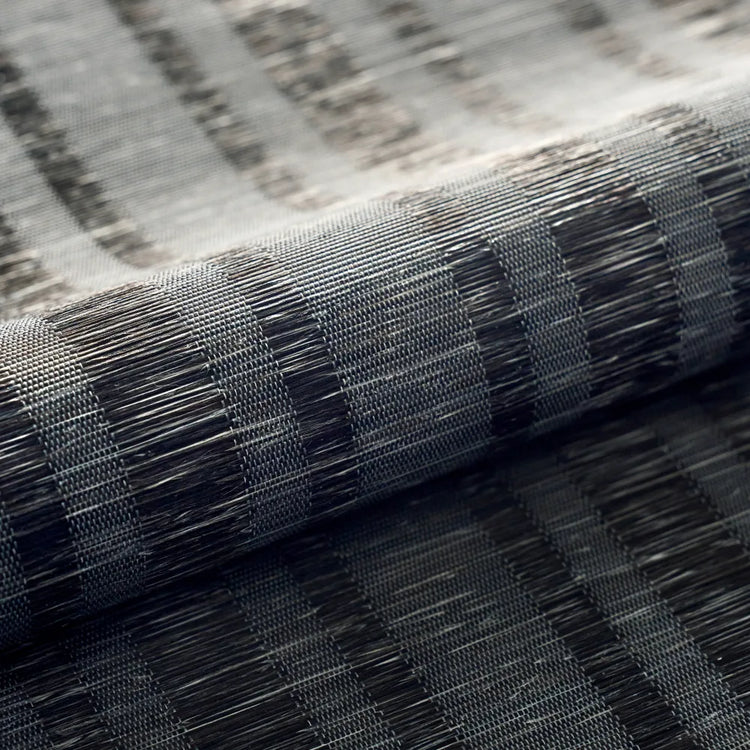 Close-up of a woven fabric or textile roll showing a striped pattern in black, gray, and white threads.
