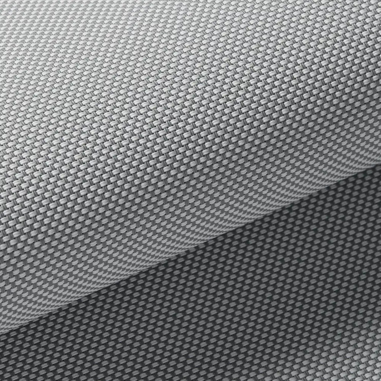 Close-up of a gray textured material with a repeating geometric pattern, shown folded to reveal the surface detail.