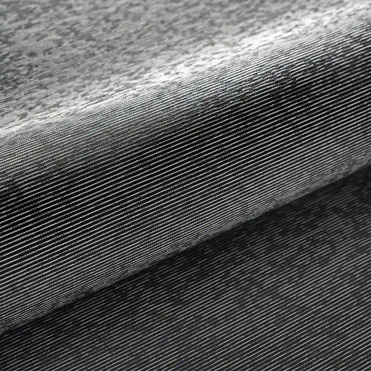 Close-up of a dark gray ribbed fabric texture with a folded layer showing fine horizontal ribbing.