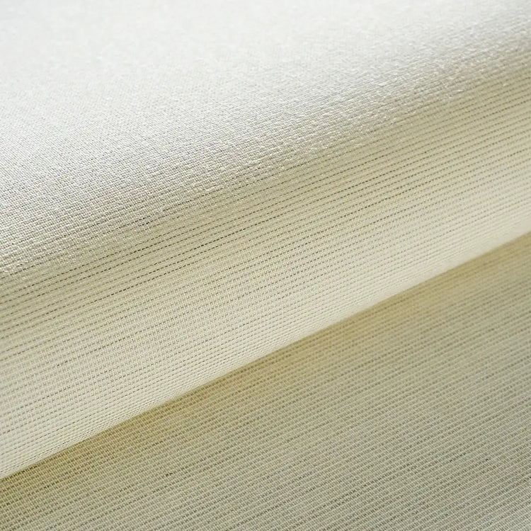 A close-up of a folded cream-colored woven fabric with a fine ribbed texture.