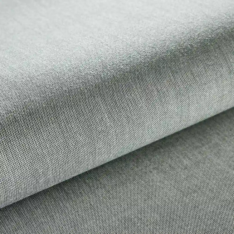A close-up of light gray woven fabric with a soft fold showing the textile texture.
