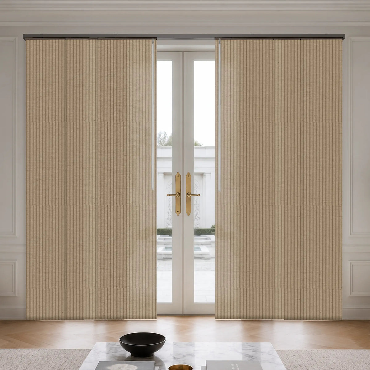 Beige textured pleated roller curtains hanging on a black rod over a set of white French doors in a bright, modern room.