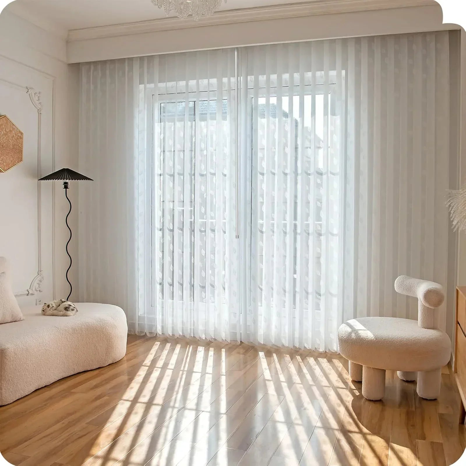 Modern living room with white curtains, a lamp, and a chair.