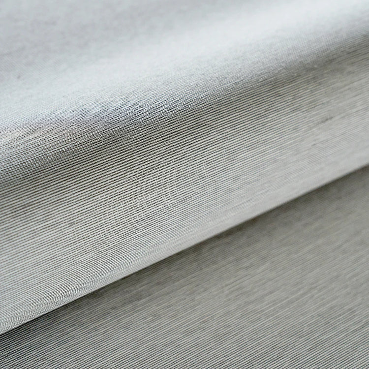 Close-up of textured gray fabric with a subtle pattern