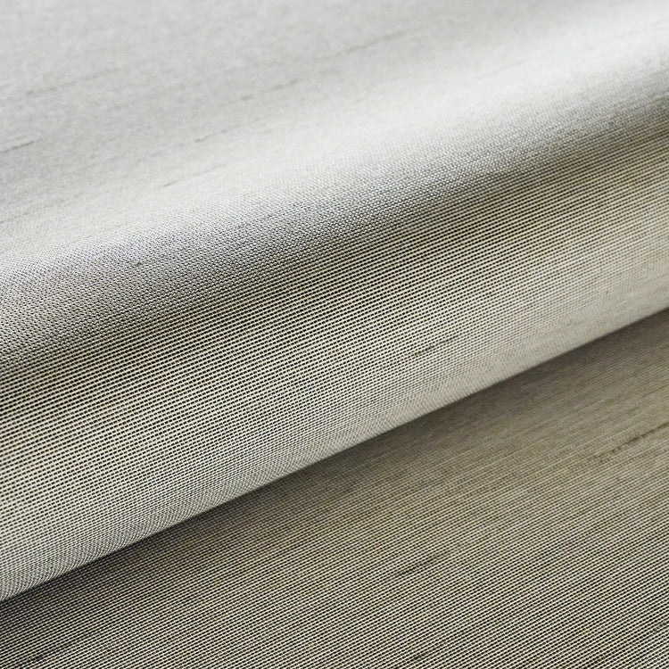 Close-up of textured beige fabric on a wooden surface