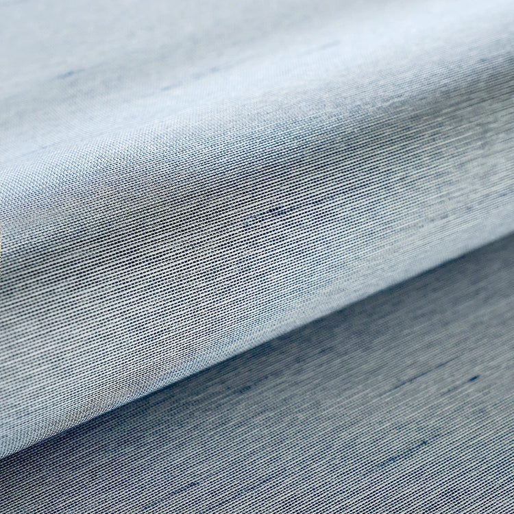 Close-up of blue fabric with a subtle pattern