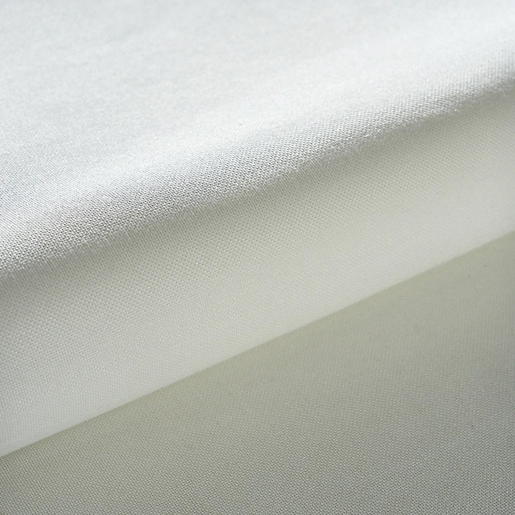 Close-up of fabric with a gradient from white to gray.