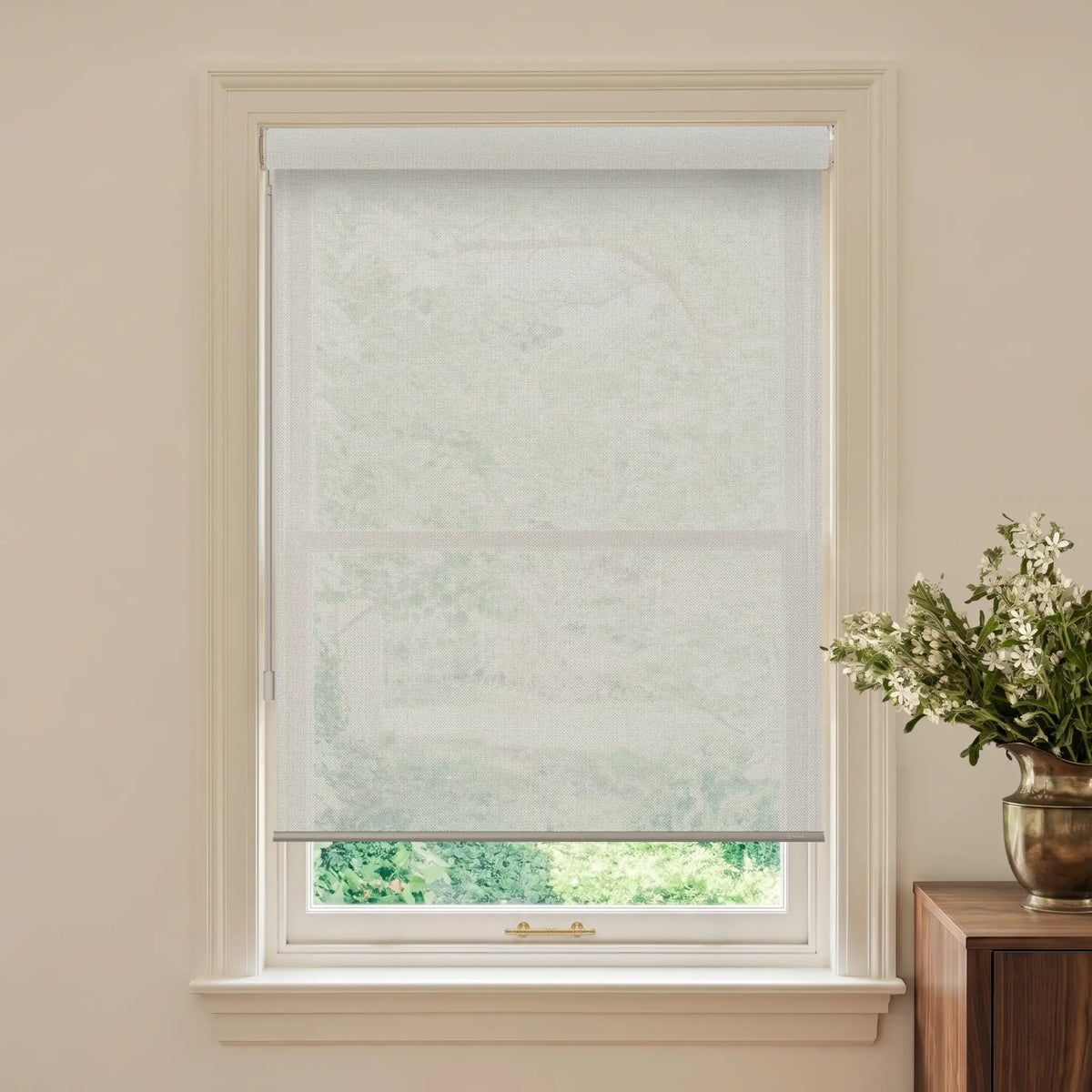 Window with a roller blind and a vase of flowers on a table.