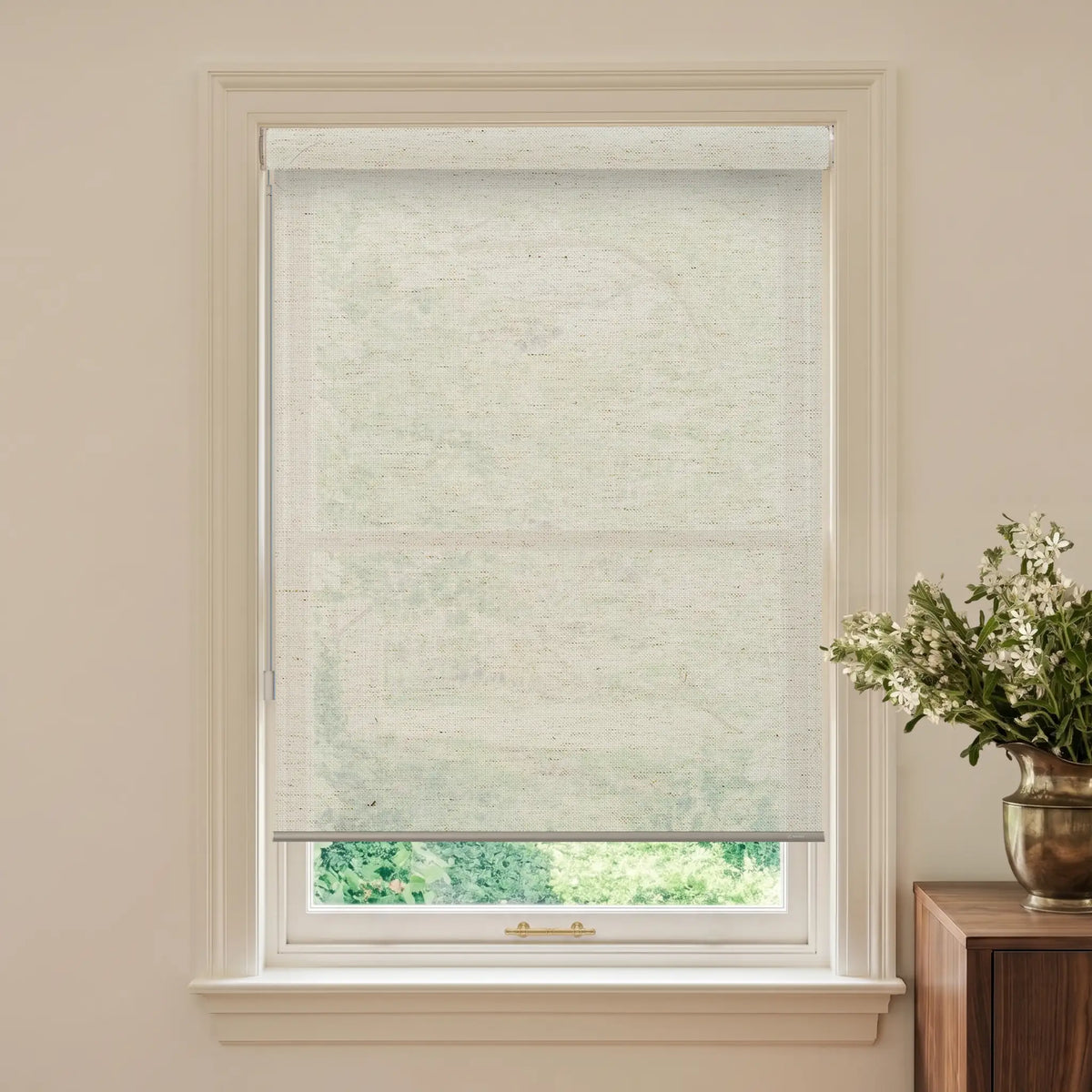 Window with a roller blind and a vase of flowers on a table.