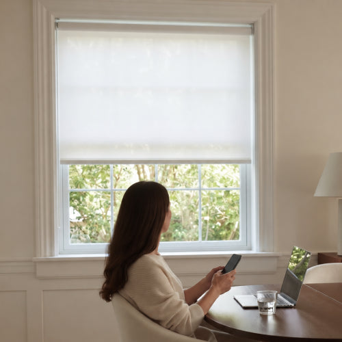  a woman is using phone app to control blinds