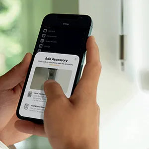 Hand holding a smartphone with a screen displaying an accessory add interface.