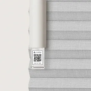 Gray woven blind with a roller and label on a white background