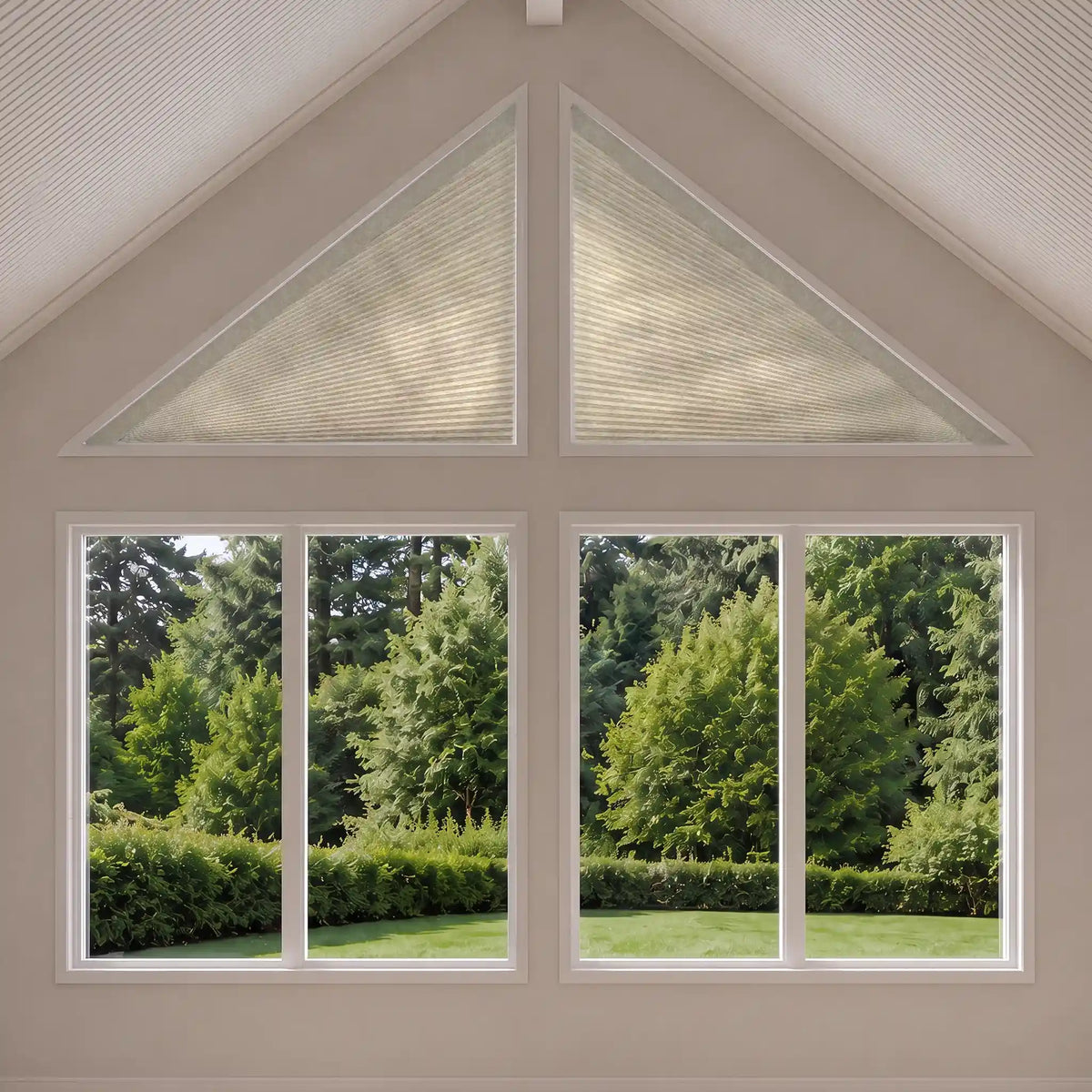 triangular window shades installed in a gable window and triangular gable-top windows, shown from an interior perspective looking out onto a green garden.
