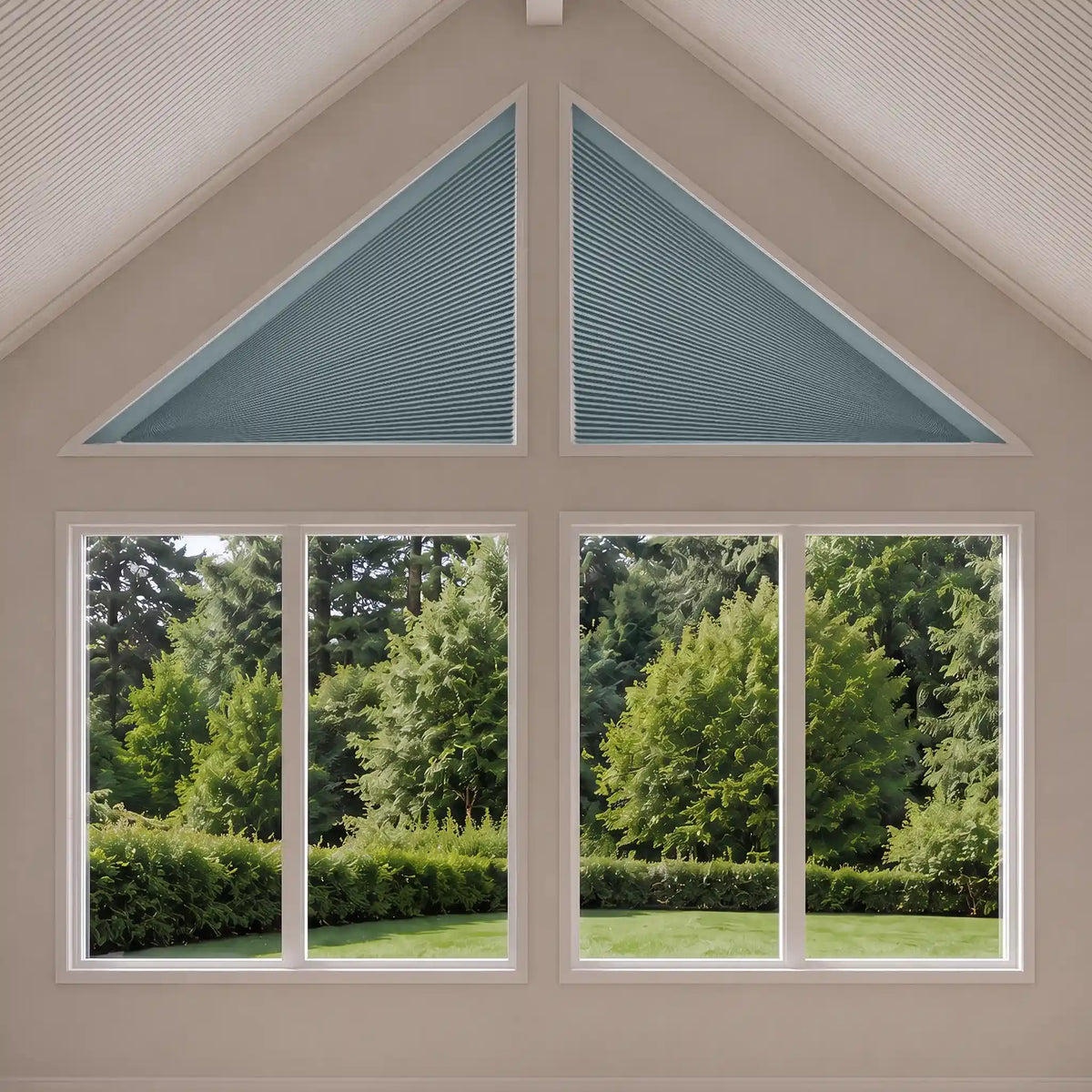 A set of light blue-gray triangular window blinds installed in the gable and upper section of a four-pane window, shown with a green garden visible outside.