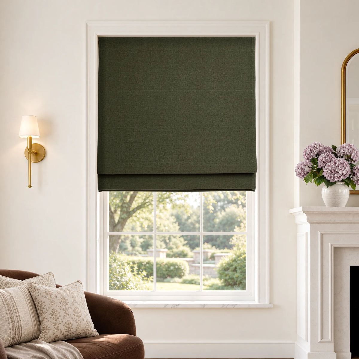 Plain fold Roman shades in Lush Moss blackout fabric, partially raised on a window.