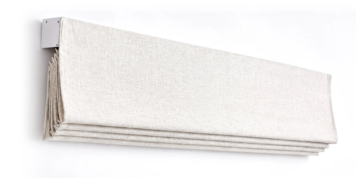 Angled view of a raised plain fold roman shade, showing stacked fabric and headrail.