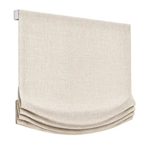 Relaxed Roman shade in light-colored fabric with a curved lower edge.