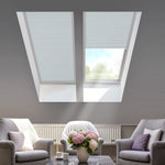Living room with skylights, furniture, and a smartphone displaying a smart home app.