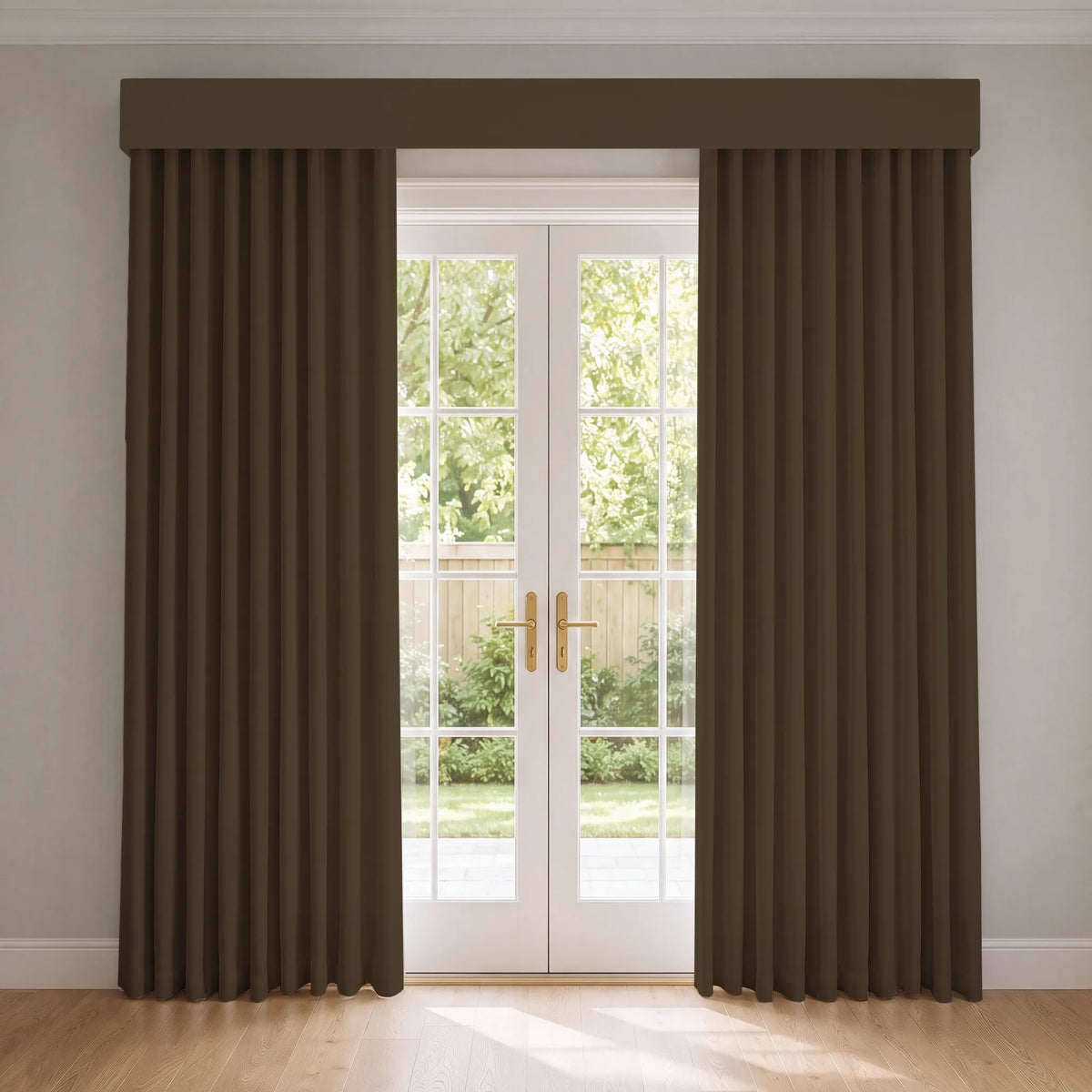 A pair of dark brown pleated smart curtain panels with a matching valance hanging on a white French door in a bright room with light wood floors.