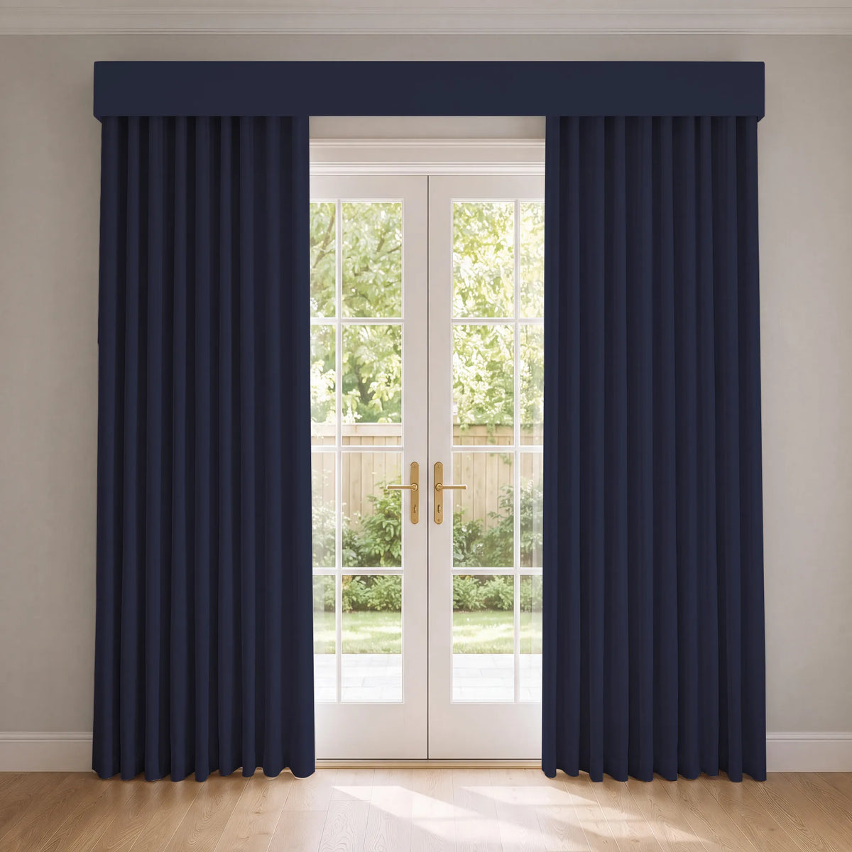 A pair of long navy blue curtain panels with a matching valance hanging on either side of white French doors, set in a room with light beige walls and a light wood floor.
