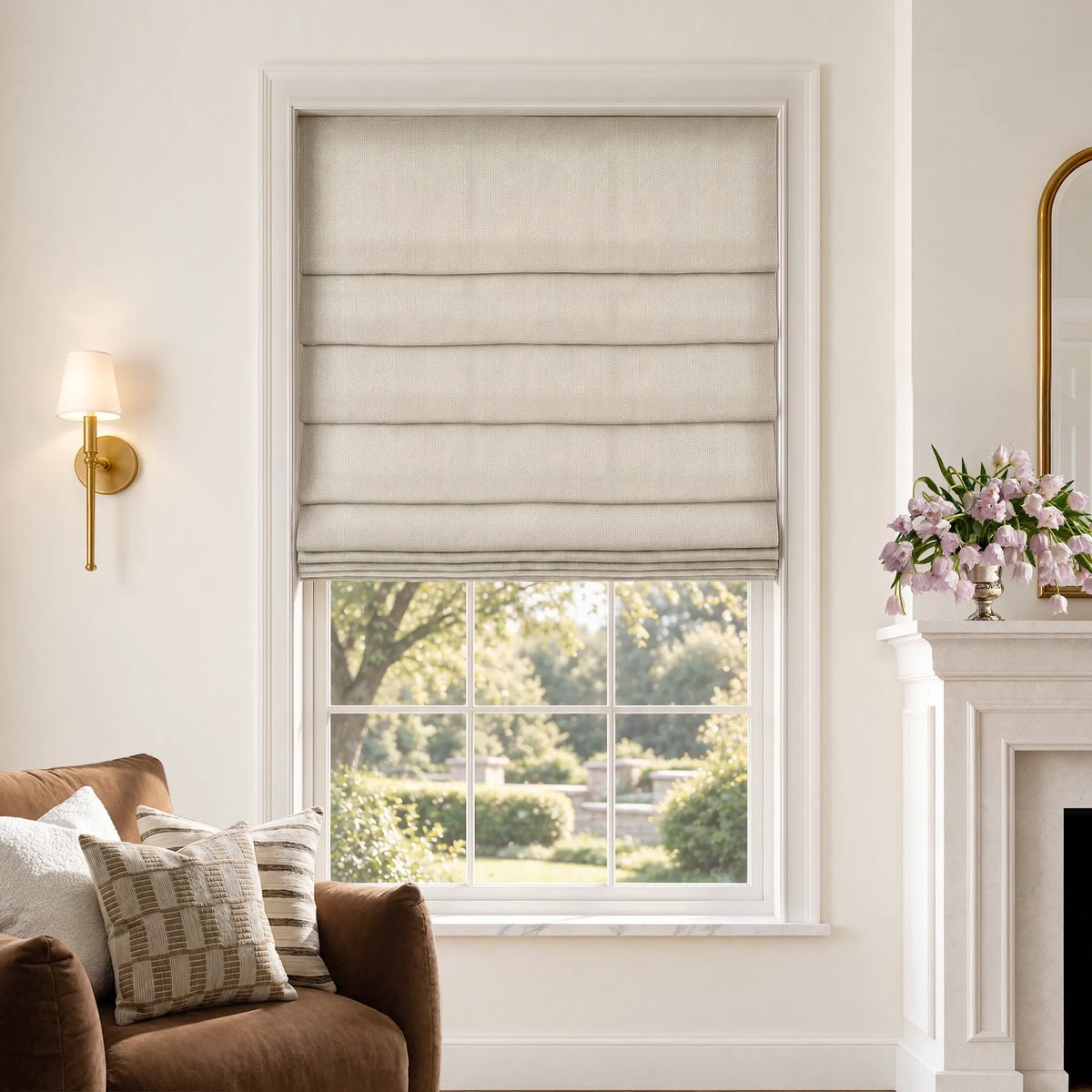 Soft fold Roman shades in Cadence Weave Oatmeal room-darkening fabric, partially raised to show cascading folds.