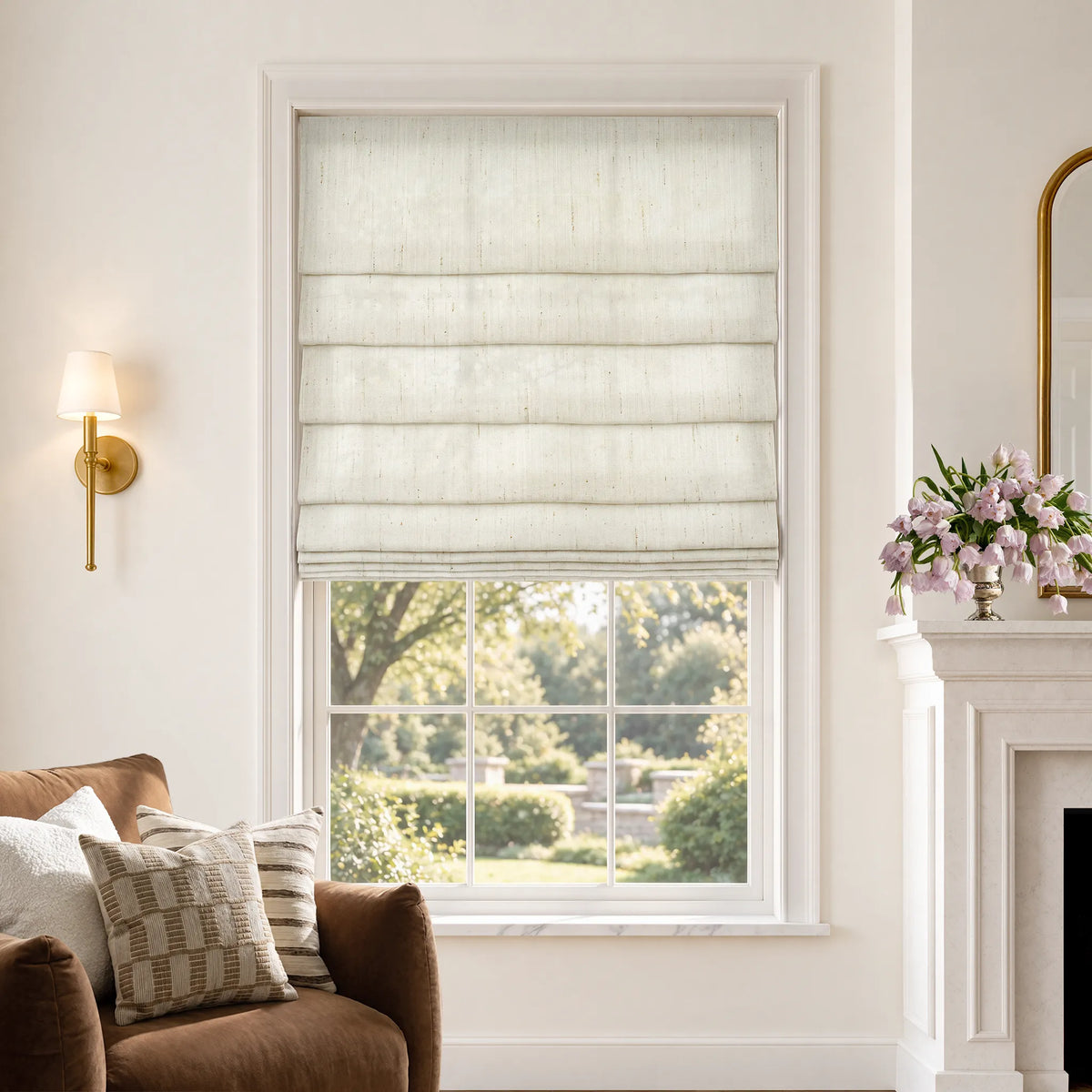 Soft fold Roman shades in Breeze White light-filtering fabric, partially raised to show cascading folds.